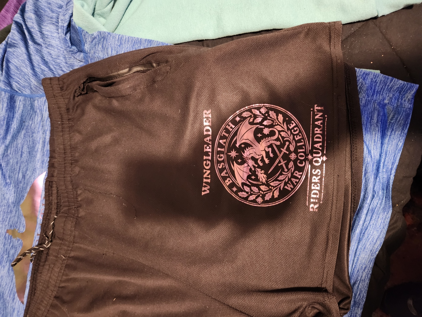 Black athletic shorts with a rose-gold Wingleader, Basgiath War College, Riders Quadrant dragon design