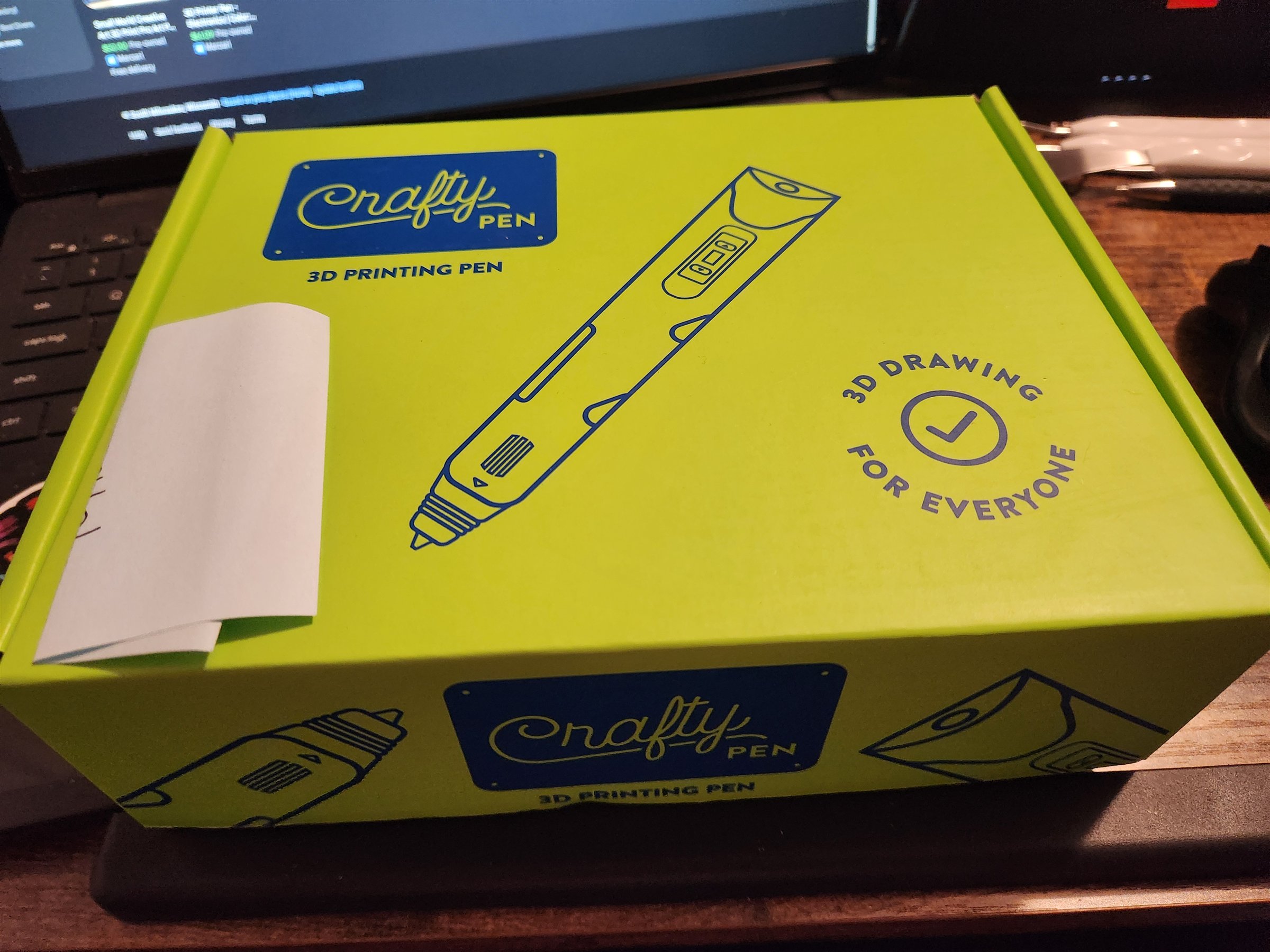 My lime-green Crafty Pen 3D Printing Pen box on my desk, labeled 3D Drawing for Everyone