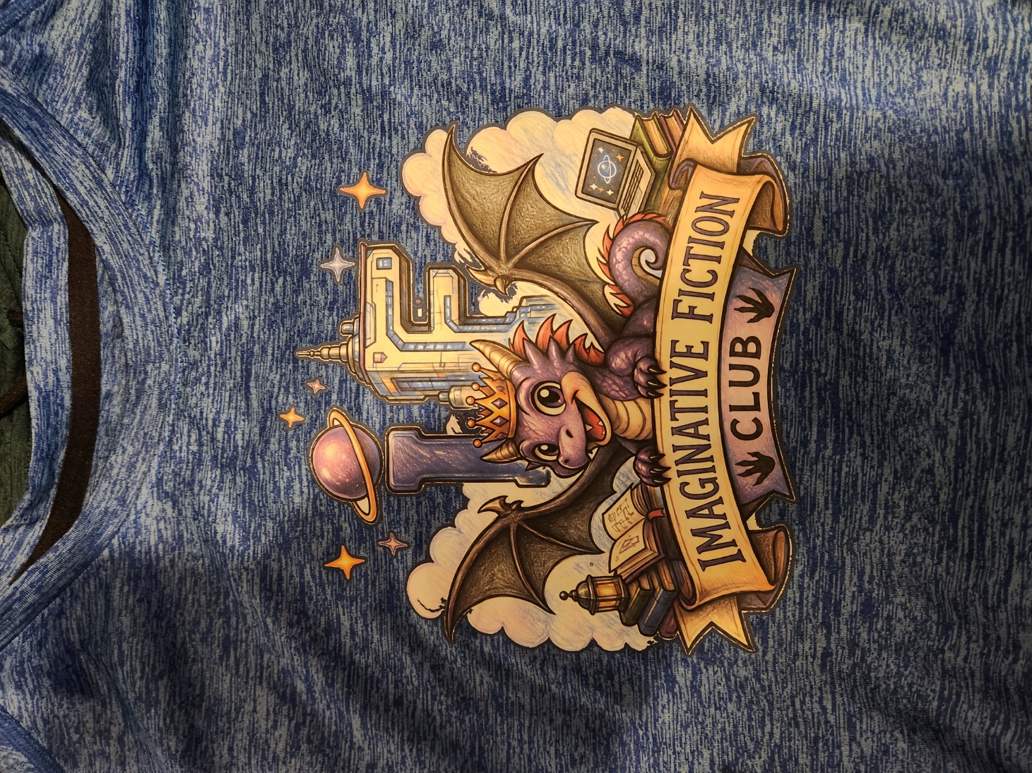 Blue shirt featuring the colorful Imaginative Fiction Club dragon, books, planet, and science-fiction tower artwork