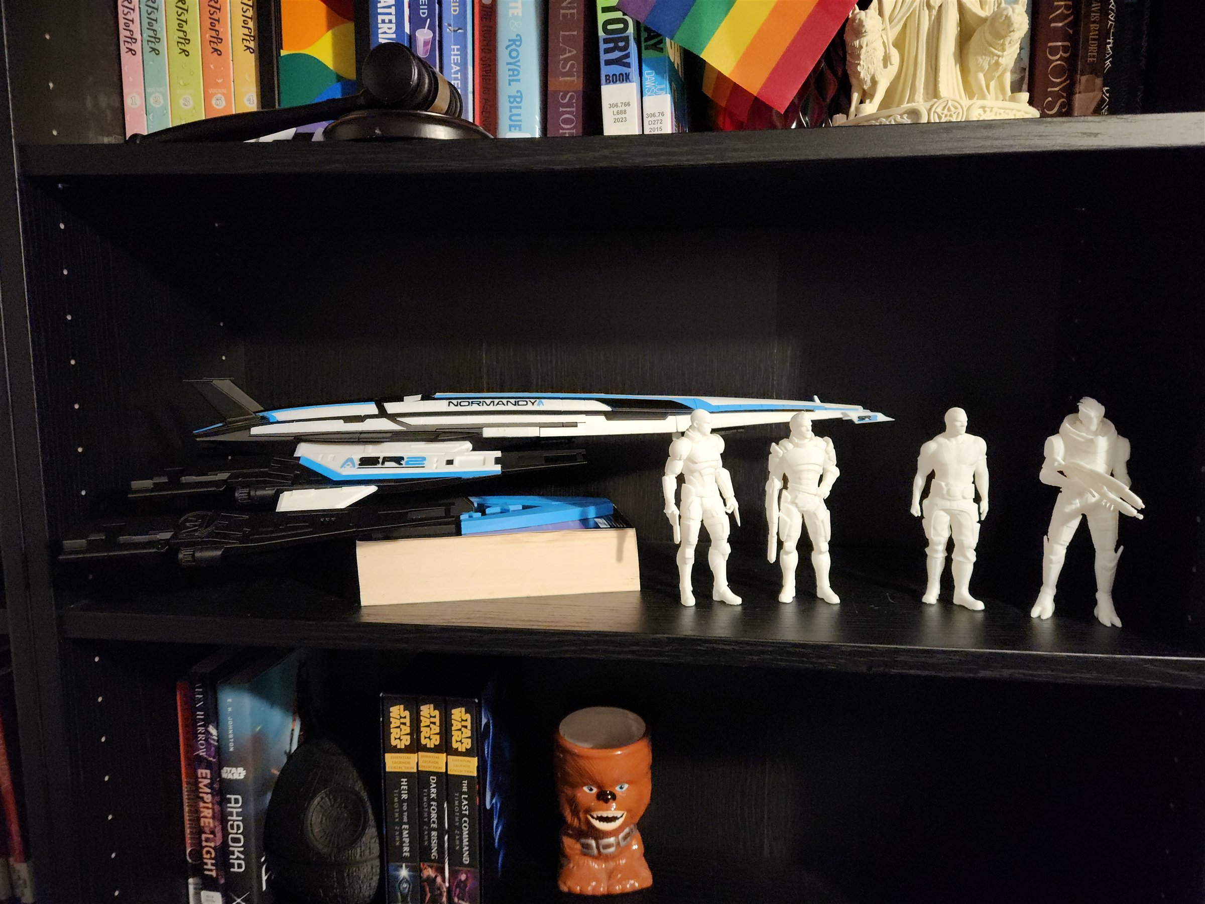 My black, white, and blue Normandy SR-2 model displayed on a bookshelf beside four unpainted character figures